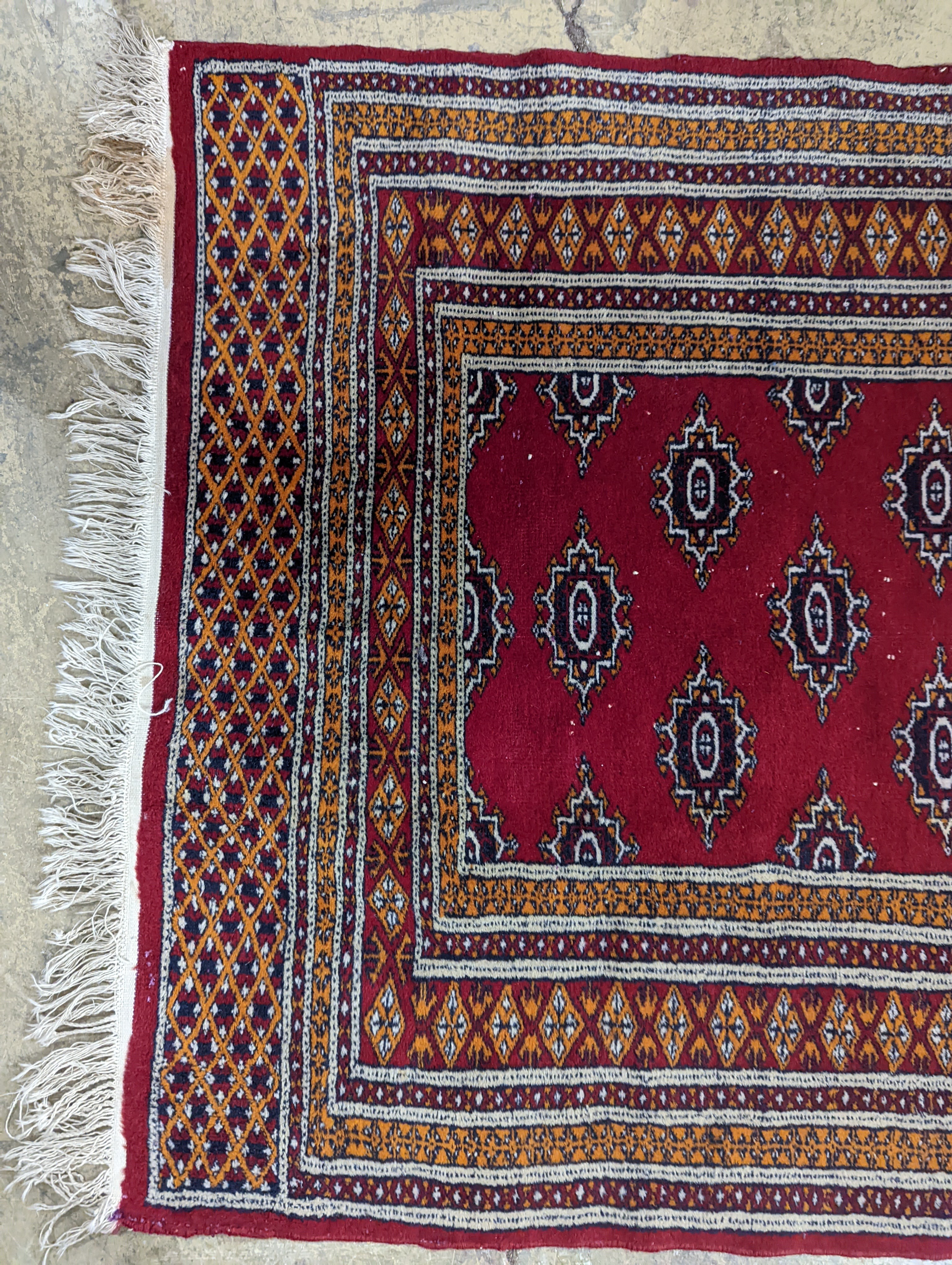 A Bokhara red ground rug, 155 x 88cm